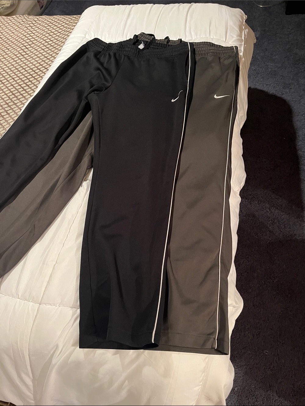Two pairs of Nike Black & Charcoal Athletic Track Pants with White Piping